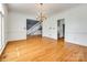 Open dining room featuring gleaming hardwood floors, natural light and views to the foyer and staircase at 15618 Eagleview Dr, Charlotte, NC 28278