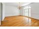 Bright dining room with hardwood floors, large windows, chandelier, and elegant wainscoting detail at 15618 Eagleview Dr, Charlotte, NC 28278