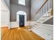 Bright foyer showcasing beautiful hardwood floors, staircase, and arched entryways, creating a welcoming ambiance at 15618 Eagleview Dr, Charlotte, NC 28278