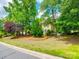 Traditional home featuring a lush front lawn with mature trees offering both curb appeal and shade at 15618 Eagleview Dr, Charlotte, NC 28278