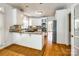 Bright eat-in kitchen boasts white cabinets, stainless appliances, and center island with granite counters at 15618 Eagleview Dr, Charlotte, NC 28278