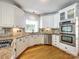 Gourmet kitchen features white cabinets, stainless appliances, and granite countertops at 15618 Eagleview Dr, Charlotte, NC 28278
