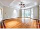 Spacious primary bedroom with tray ceilings, large windows, and hardwood floors at 15618 Eagleview Dr, Charlotte, NC 28278