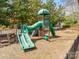 A playground is set on top of soft wood chips and has several options for slides and other play activities at 15618 Eagleview Dr, Charlotte, NC 28278
