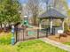 A playground is fenced in with benches and green grass to enjoy at 15618 Eagleview Dr, Charlotte, NC 28278
