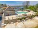 A community pool with lounge chairs and tables overlooks a sandy beach and a body of water at 15618 Eagleview Dr, Charlotte, NC 28278