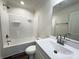 Bright bathroom with a shower-tub and vanity with chrome fixtures at 159 Hallman St, Cherryville, NC 28021