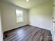 Well-lit bedroom with modern flooring and a window offering a pleasant view at 159 Hallman St, Cherryville, NC 28021