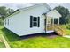 The charming home features a well-manicured lawn and classic white siding at 159 Hallman St, Cherryville, NC 28021