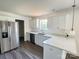 Modern kitchen boasts stainless steel appliances, white cabinets, and ample counter space at 159 Hallman St, Cherryville, NC 28021