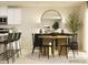 Stylish dining area featuring a round wooden table, black chairs, a modern light fixture, and a decorative mirror at 1613 Spring Lot Dr, Edgemoor, SC 29712