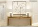 Well-lit entryway featuring a wooden console table adorned with lamps and decor, leading to adjacent rooms at 1613 Spring Lot Dr, Edgemoor, SC 29712