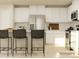 Modern kitchen with white cabinets, stainless steel appliances, a stylish backsplash, and barstool seating at 1613 Spring Lot Dr, Edgemoor, SC 29712