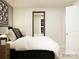 Serene bedroom showcasing a king-size bed, stylish nightstand, modern artwork, and a bright window at 1613 Spring Lot Dr, Edgemoor, SC 29712