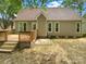 Backyard view featuring a wooden deck, well-maintained exterior, and a serene outdoor space at 1625 Winthrop Ln, Monroe, NC 28110