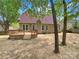Backyard featuring a wooden deck, well-maintained exterior, and a serene outdoor space at 1625 Winthrop Ln, Monroe, NC 28110