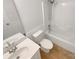 Well-lit bathroom with tile floors, modern sink, vanity, mirror, and shower-tub combo at 1625 Winthrop Ln, Monroe, NC 28110