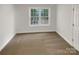 Clean, empty bedroom with neutral carpet, a large window, and a bright, airy feel at 1625 Winthrop Ln, Monroe, NC 28110