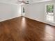 Spacious bedroom featuring hardwood floors, neutral walls, natural light from two windows, and ceiling fan at 1625 Winthrop Ln, Monroe, NC 28110