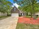 Charming two-story brick home with an attached garage and beautifully landscaped front yard at 1625 Winthrop Ln, Monroe, NC 28110