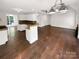 Open-concept living space showcasing hardwood floors, white walls, and modern lighting fixtures at 1625 Winthrop Ln, Monroe, NC 28110