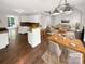 Bright, open-concept living room and kitchen area with hardwood floors, stylish lighting, and modern decor at 1625 Winthrop Ln, Monroe, NC 28110