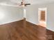Large main bedroom featuring wood floors, ceiling fan, and ensuite bathroom at 1625 Winthrop Ln, Monroe, NC 28110