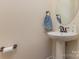Bright bathroom with pedestal sink, oval mirror, and modern fixtures at 1720 Fleetwood Dr, Charlotte, NC 28208