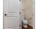 Powder room featuring a toilet, hardwood floors, and white walls at 1720 Fleetwood Dr, Charlotte, NC 28208
