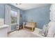 This Bedroom has a crib and chair, plus natural light streams through the window at 1720 Fleetwood Dr, Charlotte, NC 28208