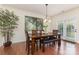 Elegant dining room with a wooden table, bench seating, and a sliding glass door at 1720 Fleetwood Dr, Charlotte, NC 28208