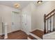 Inviting home foyer featuring hardwood floors, stairs, and natural light at 1720 Fleetwood Dr, Charlotte, NC 28208