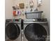 Laundry room with a gray Samsung washer and dryer and wire shelving at 1720 Fleetwood Dr, Charlotte, NC 28208