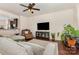 Cozy living room featuring hardwood floors, modern ceiling fan, and comfortable furnishings at 1720 Fleetwood Dr, Charlotte, NC 28208