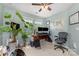 A home office with a desk, chair, and two windows, and a large leafy plant at 1720 Fleetwood Dr, Charlotte, NC 28208