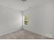 This carpeted bedroom offers a single window for natural light at 197 Park View Dr, Stanfield, NC 28163