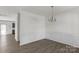 Open dining area featuring modern floors, wainscoting, and a contemporary chandelier at 197 Park View Dr, Stanfield, NC 28163