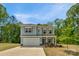 Inviting two-story home showcasing a manicured lawn and a convenient two-car garage at 197 Park View Dr, Stanfield, NC 28163