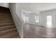 Open Foyer with stairs and luxury vinyl plank flooring leading to the living room at 197 Park View Dr, Stanfield, NC 28163