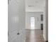 Bright hallway with wood-look flooring leading to a sunlit back door and cabinets at 197 Park View Dr, Stanfield, NC 28163