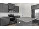 Kitchen featuring stainless steel appliances, granite countertops, gray cabinetry, and subway tile backsplash at 197 Park View Dr, Stanfield, NC 28163