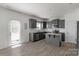 Kitchen with grey cabinets, stainless steel appliances, and island with granite countertops at 197 Park View Dr, Stanfield, NC 28163