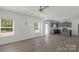 Open-concept living room with gray cabinets, stainless appliances, and hardwood style flooring at 197 Park View Dr, Stanfield, NC 28163