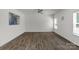 Living room offers a spacious layout, ceiling fan, and vinyl floors at 197 Park View Dr, Stanfield, NC 28163