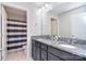 Well-lit bathroom with double sinks, granite countertops, and a shower/tub combination with a striped curtain at 2014 Burton Point Ct, Waxhaw, NC 28173