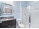 Bathroom with granite vanity, large mirror, glass enclosed shower, and tile flooring at 2014 Burton Point Ct, Waxhaw, NC 28173