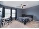 Modern bedroom with a dedicated workspace including modern desk and chair and a large window at 2014 Burton Point Ct, Waxhaw, NC 28173