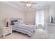 The bedroom is well-lit and features a queen size bed, a dresser, a nightstand, and curtains at 2014 Burton Point Ct, Waxhaw, NC 28173
