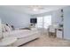 Bright bedroom with a well-lit desk, window, and television on dresser for working or relaxing at 2014 Burton Point Ct, Waxhaw, NC 28173