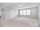 Large bonus room featuring neutral tones, plush carpeting, and abundant natural light for versatile use at 2014 Burton Point Ct, Waxhaw, NC 28173